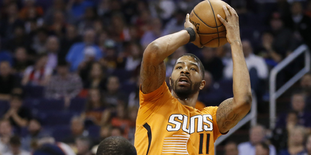 Phoenix Suns' Markieff Morris (11) shoots over Minnesota Timberwolves' Mo Williams during the secon...