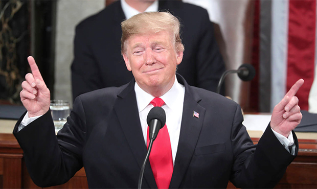 President Donald Trump gestures as a conductor as people in the chamber sing "Happy Birthday" to Ju...