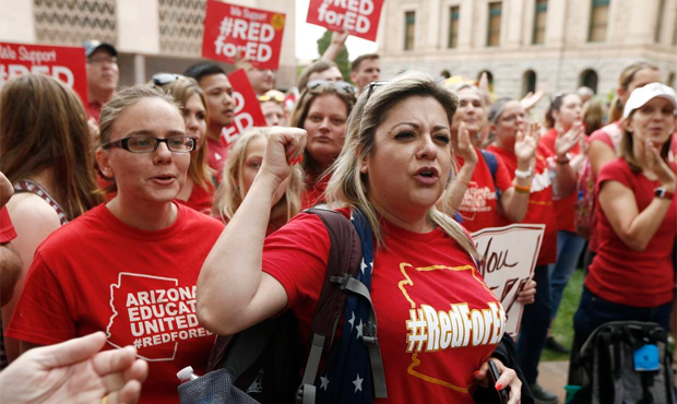 Arizona teacher Aurelia Ionescu, front right, chants with other teachers as protest organizers anno...