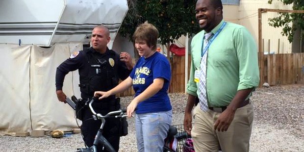 Chandler Police Officer Ruben Sanchez gifts a young woman with a new bicycle. (Facebook/Chandler Po...