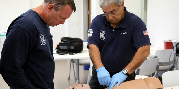 Phoenix Fire Department Capt. David Sanchez, right, and Capt. Scott Petersen practice needle decomp...