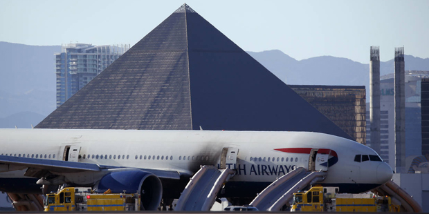 Casinos along the Las Vegas Strip can be seen behind a plane that caught fire at McCarren Internati...