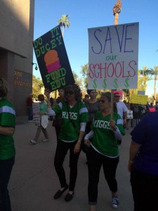 Two women march at a Phoenix protest in March against budget cuts for education. (Twitter/suerthjessica)