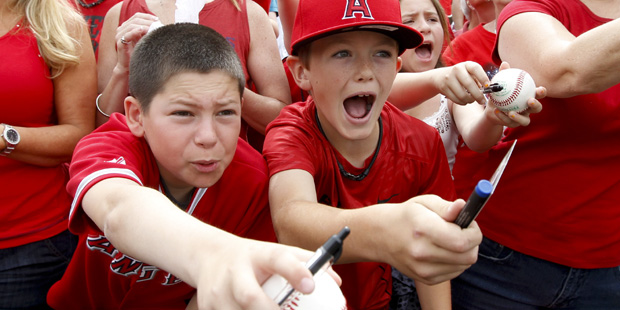 Young fans try for autographs by Los Angeles Angels first baseman Albert Pujols before a spring tra...
