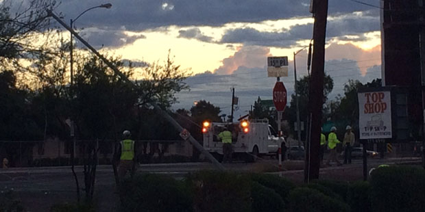 A utility company crew works to restore power to a Phoenix neighborhood after a storm on Sept. 14, ...