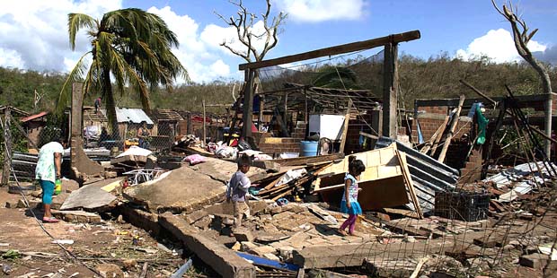 Residents walk through the debris of homes destroyed by Hurricane Patricia, in Chamela, Mexico, Sat...