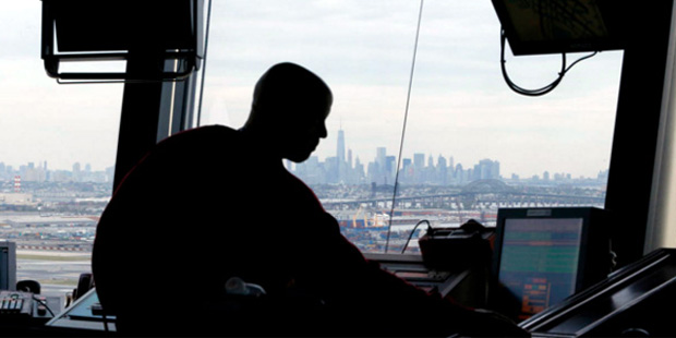 In this May 21, 2015 file photo, an air traffic controller works in the tower at Newark Liberty Int...