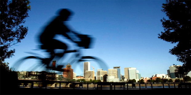 In this July 10, 2008, file photo, a bicyclist travels along the east bank of the Willamette River ...