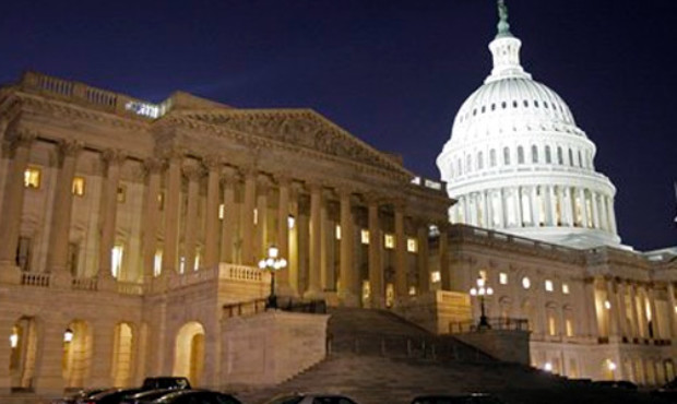 The lights burn inside of the House of Representatives side of the U.S. Capitol late Saturday night...
