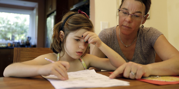 Stacey Jacobson-Francis, right, works on math homework with her 6 year old daughter Luci Wednesday,...