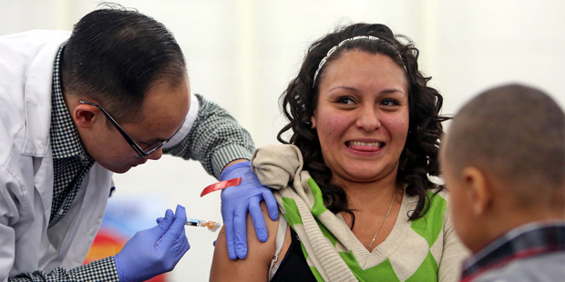 Woman receives flu shot. (AP Photo)...