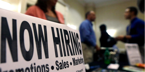 In this Thursday, Oct. 25, 2012, file photo, a sign attracts job-seekers during a job fair at the M...