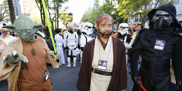 Star Wars fans dressed in costumes of Star Wars characters pose for a photo during a Halloween para...