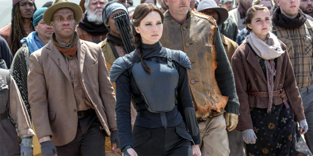 This image released by Lionsgate shows Jennifer Lawrence as Katniss Everdeen, center, in a scene fr...