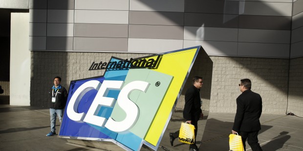 People walk by a sign outside of the International CES, Friday, Jan. 9, 2015, in Las Vegas. (AP Pho...