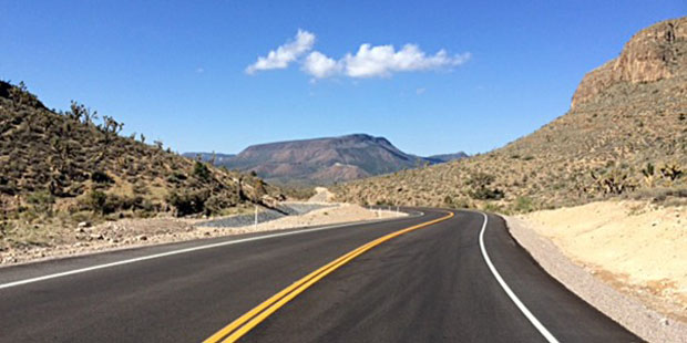 This undated photo provided by Fann Contracting, Inc. shows a newly-paved stretch of road leading t...