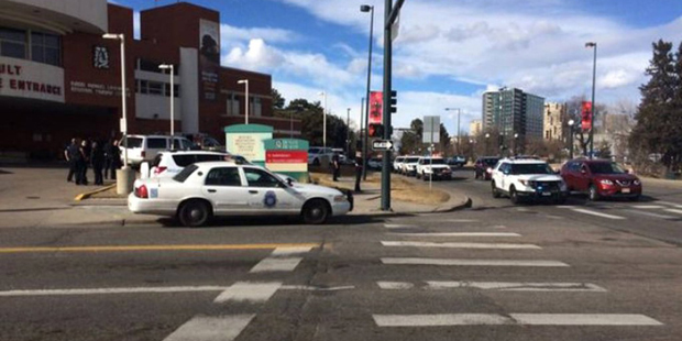 In this photo provided by 9NEWS/KUSA-TV Denver, authorities respond to the scene of a deadly shooti...