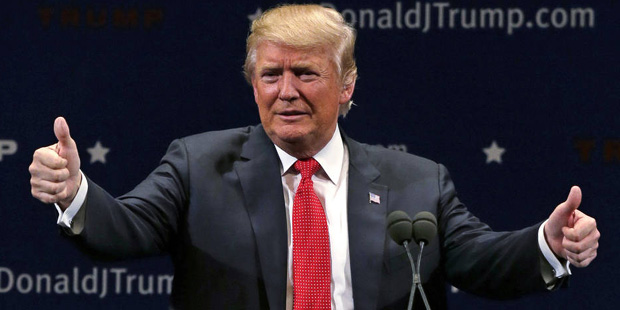 Republican presidential candidate Donald Trump flashes thumbs up after an address to a group of sup...