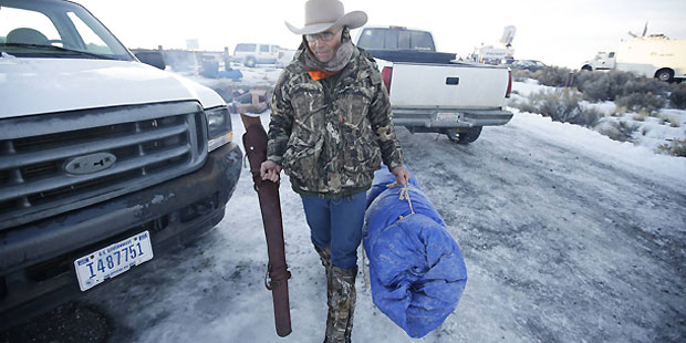In this Jan. 6, 2016 file photo, Arizona rancher LaVoy Finicum carries his rifle after standing gua...