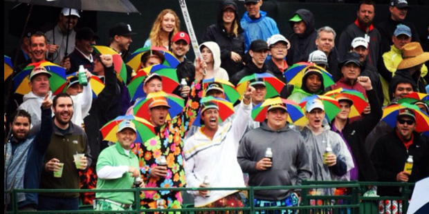 Fans at the Waste Management Phoenix Open at TPC Scottsdale in January 2015 don themselves with umb...