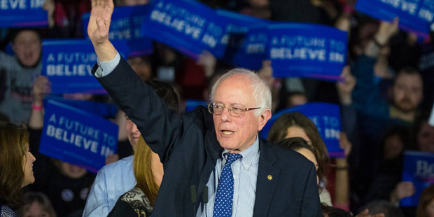 Democratic presidential candidate, Sen. Bernie Sanders, I-Vt, waves to the crowd at his caucus nigh...