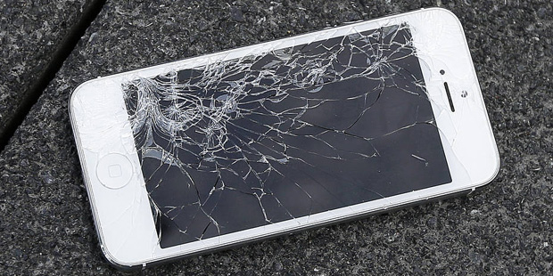 This Aug. 26, 2015 photo shows an Apple iPhone with a cracked screen after a drop test from the Dro...