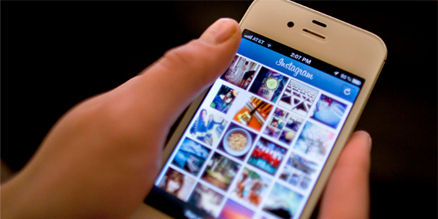 File-This April 9, 2012, file photo shows Instagram being demonstrated on an iPhone in New York. So...