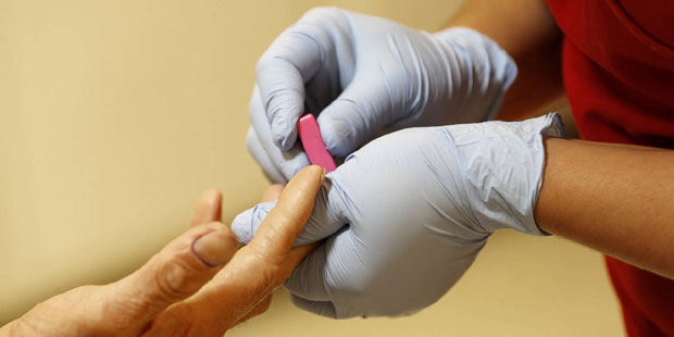FILE - In this Wednesday, May 1, 2013, file photo, a lab technician draws blood from a patient at a...