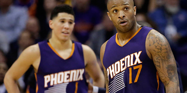 Phoenix Suns' P.J. Tucker (17) and Devin Booker (1) react to a foul call during the second half of ...