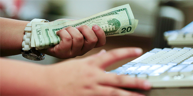 FILE - In this Friday, Nov. 23, 2012 file photo, a cashier rings up a sale at a Sears store, in Las...