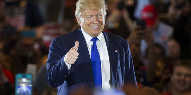 Republican presidential candidate Donald Trump gives a thumbs-up as he speaks during a campaign sto...