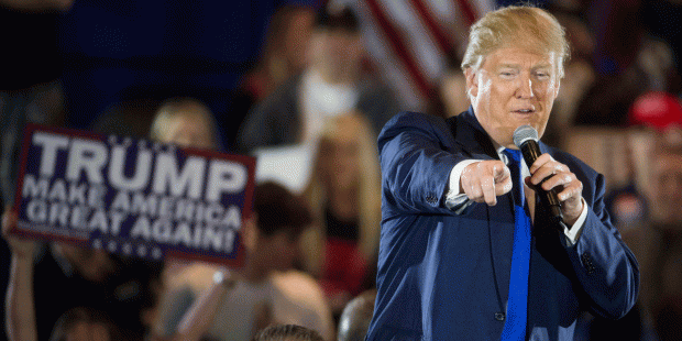 Republican presidential candidate Donald Trump speaks alongside a member of the Secret Service duri...
