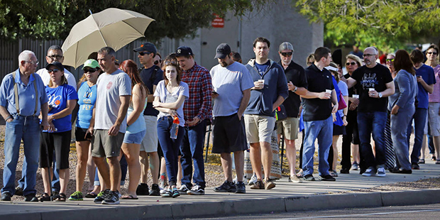 People wait in line to vote in the Arizona Presidential Primary Election at Mountain View Lutheran ...
