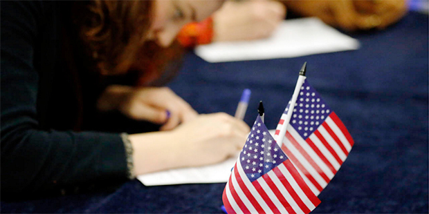 Voters fill out their ballot papers in London, Tuesday, March 1, 2016 as voting begins in the U.S. ...