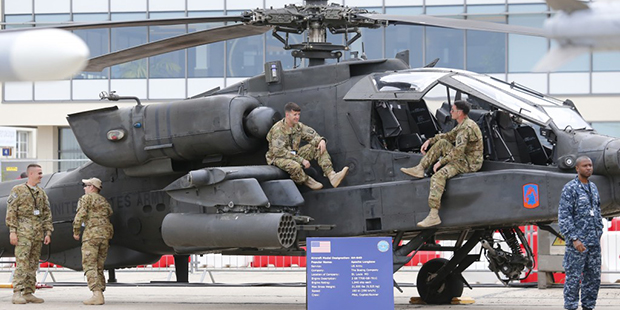 U.S army personnel stand on the Boeing Helicopter AH-64D Apache Longbow at the Paris Air Show in le...