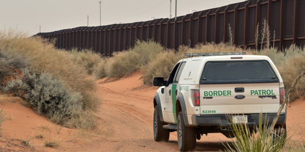 FILE - In this Jan. 4, 2016 photo, a U.S. Border Patrol agent drives near the U.S.-Mexico border fe...