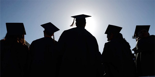 In this June 18, 2014 file photo, High School graduates stand and sing during graduation ceremonies...