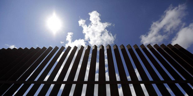 In this Sept. 15, 2015, photo, a borer fence a farmers property, Tuesday, in Mission, Texas. The st...