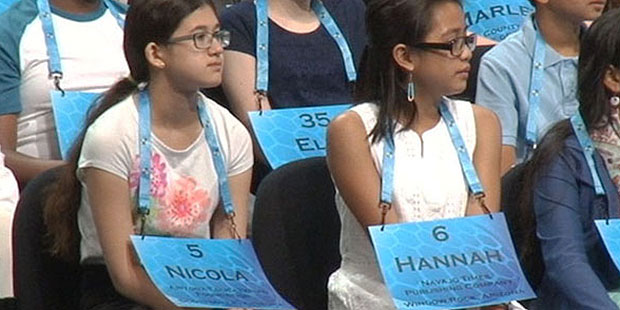 Nicola Ferguson (left) and Hanna Norilyn May Batnag Pengroso sit on stage with other contestants We...