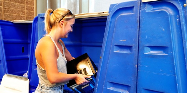 Business freshman Meg Myers places a microwave into a donation bin as part of Ditch the Dumpster. E...