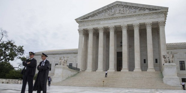 Police stand outside the Supreme Court in Washington, Thursday, June 23, 2016. (AP Photo/Evan Vucci...