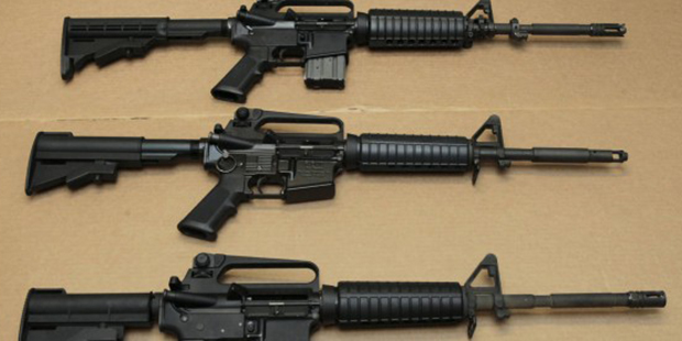 FILE — In this Aug. 15, 2012 file photo, three variations of the AR-15 assault rifle are disp...