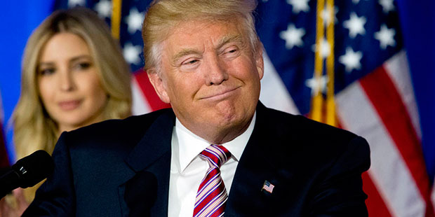 Republican presidential candidate Donald Trump smiles as supporters cheer during a news conference ...