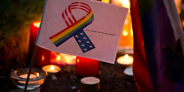 A tribute message and design stands amongst candles laid at Saint Anne's Church in the Soho distric...