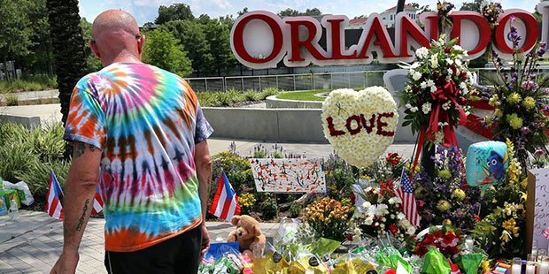 Visitors pay the respects at a makeshift memorial at Orlando Regional Medical Center, a few blocks ...