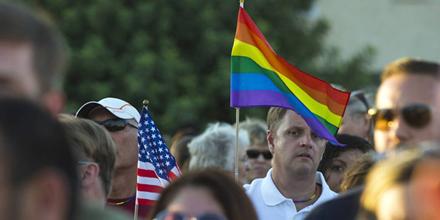 People gather to support the victims of the Orlando, Fla., nightclub shooting outside Phoenix Pride...