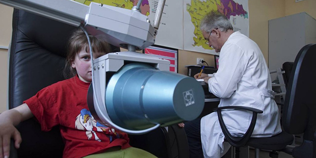 In this photo taken on Tuesday, April  5, 2016, a pediatrician performs yearly check for radioactiv...