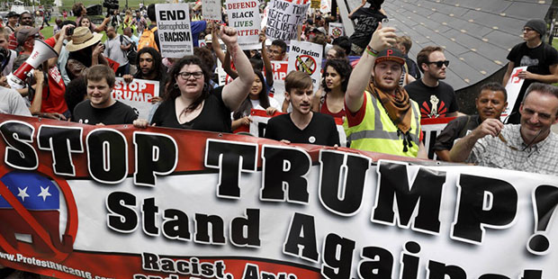 Protestors yell during a rally against Republican presidential candidate Donald Trump on Monday, Ju...