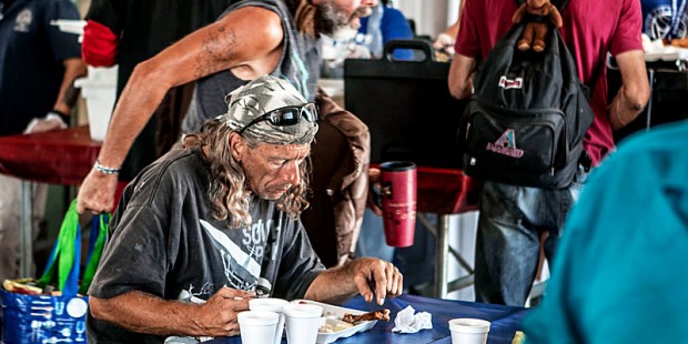 Homeless community in Mesa enjoying a hot meal at Paz de Cristo community center. (Photo by Isabel ...