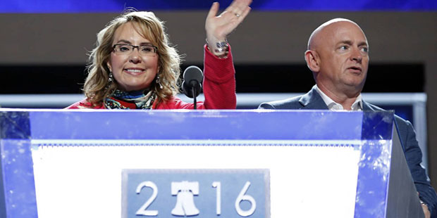 Former Rep. Gabby Giffords, D-Ariz, waves from the podium as her husband Astronaut Mark Kelly (ret....